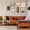 Gallery of trendy posters in elegant grey living room interior with brown corner sofa