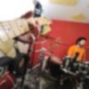 band practicing loudly in a soundproofed room with drums and instruments
