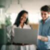 two people looking at acoustical testing results on a MacBook
