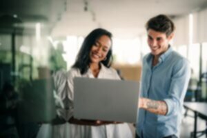 two people looking at acoustical testing results on a MacBook